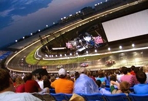 Crowds of people inside the Lowe's Motor Speedway stadium view the CARS WORLD PREMIERE SHOOTOUT race. 